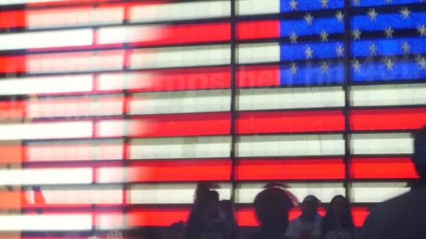 New York City, United States - 5 Sept 2023: Times Square, Manhattan Midtown Broadway street, USA. American flag, NYC urban life. Military island, army recruiting. People pedestrians silhouettes, crowd