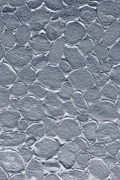 Metallic silver textured background forming a seamless pattern of smooth pebbles, ideal for design projects