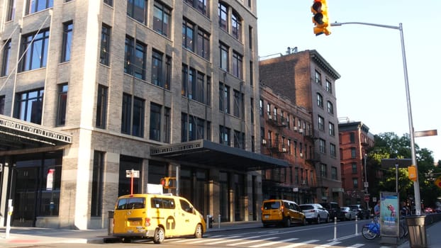 New York City, United States - 2 Sept 2023: Manhattan Midtown street in Chelsea, 9 avenue crossroad intersection. Meatpacking district urban road car traffic, USA. People pedestrians. Yellow taxi cab.