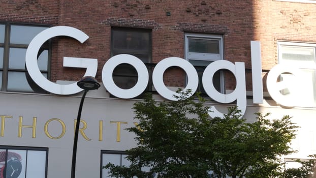 New York City, United States - 1 Sept 2023: Manhattan Midtown street or avenue. Urban red brick architecture USA. Google logo, logotype sign. NYC headquarters office near Chelsea Market and High Line.