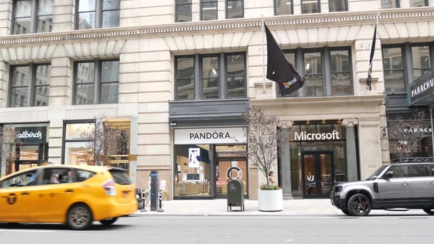 New York City, United States - 8 Sept 2023: Manhattan Midtown street, Fifth 5 avenue. American urban road car traffic. Yellow taxi cab in USA. People pedestrians. Boutique fashion stores for shopping