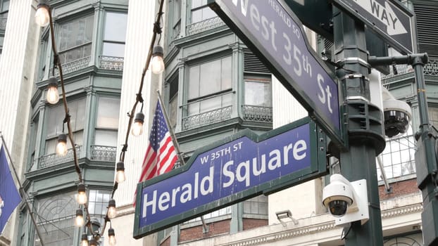 New York City, United States, 29 Aug 2023: Manhattan Broadway. Street intersection road sign. Midtown district architecture, Herald Square park, 6 Sixth avenue crossroad, United States. American flag.