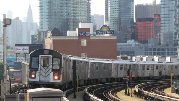 New York City, United States - 2 Sept 2023 Subway station. Metro train public transportation platform. Elevated railway, Queens passenger railroad traffic, Long Island skyline. Chrysler building.
