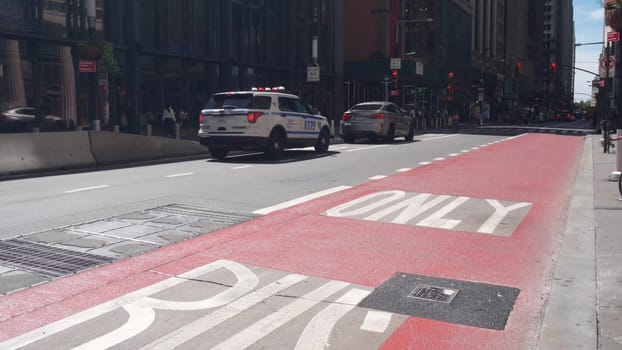 New York City, United States - 31 Aug 2023: Police department patrol car, USA NYPD, 911 vehicle on Manhattan Midtown street. American cop auto on avenue, urban road traffic in NYC. Bus only red lane.