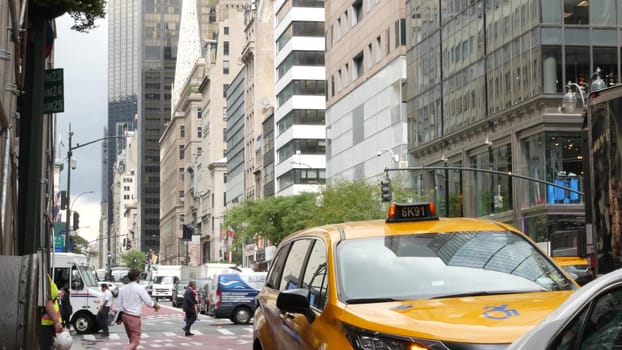 New York City, United States - 13 Sept 2023: Manhattan Midtown street, 5th, Fifth 5 avenue. American urban road car traffic. Yellow taxi cab in USA. People, pedestrians on zebra. USPS postal truck.