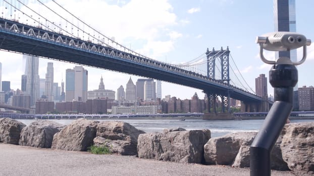 New York City, United States - 30 Aug 2023: Manhattan Bridge lookout, tower viewer binoculars, Brooklyn Dumbo. Waterfront downtown cityscape, skyscraper skyline. East River tourist promenade.