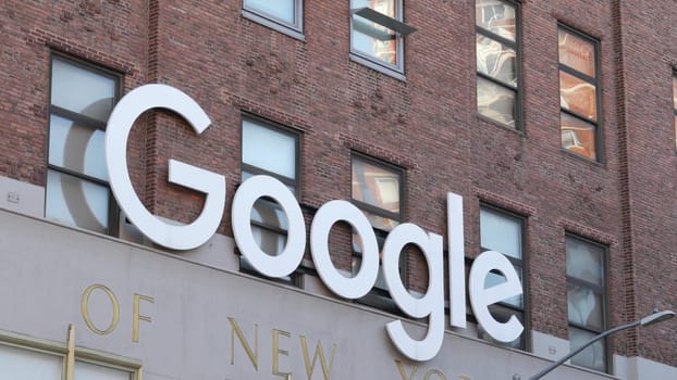 New York City, United States - 1 Sept 2023: Manhattan Midtown street or avenue. Urban red brick architecture USA. Google logo, logotype sign. NYC headquarters office near Chelsea Market and High Line.