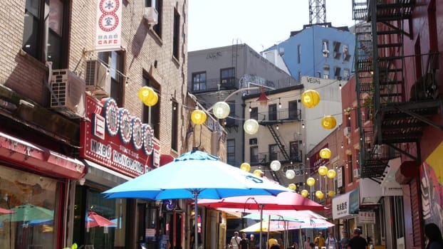 New York City, United States - 14 Sept 2023: Manhattan Chinatown Doyers street, chinese ethnic district building architecture. People, festive paper lanterns, street food umbrellas. Water tower tank.