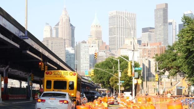 New York City, United States - 7 Sept 2023: Yellow School Bus on street, schoolbus truck on city road. Manhattan Downtown. Children education and USA transportation. American school shuttle. FDR Drive