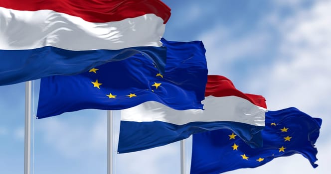 3D render of the Dutch flag and European Union flag fluttering side by side, symbolizing unity, democracy and European identity on a clear day.