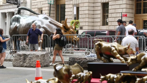 New York City, United States - 9 Sept 2023: Charging Bull, Wall street Stock Exchange symbol in USA. Lower Manhattan Downtown Financial District. American Broadway street. Tourist people photographing