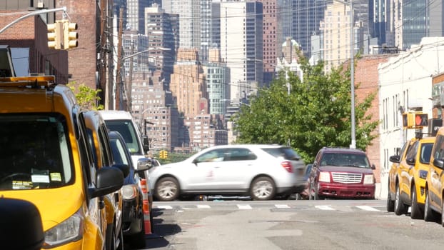 New York City, United States - 1 Sept 2023: Row of yellow taxi cars on street, Queens. Taxi cab on avenue, Long Island. Medallion taxicab. Manhattan Midtown urban skyline cityscape. High-rise building