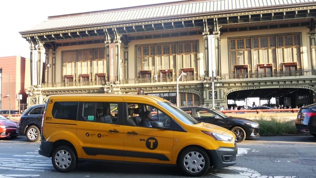 New York City, United States - 4 Sept 2023: Manhattan Downtown Financial District. USA city life. Road car traffic. Yellow taxi, people. Battery Maritime Building ferry terminal, Whitehall Street.