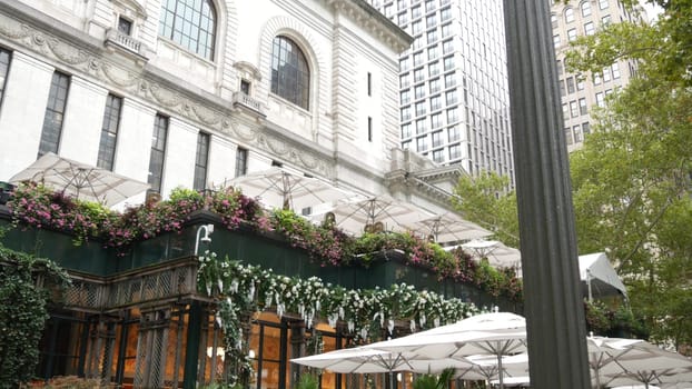 New York City, United States - 13 Sept 2023: Manhattan Midtown Bryant Park with Public library, 42 street and 5th Fifth 5 avenue. USA landmark. Summer cafe greenery, garden flowers bloom and building.