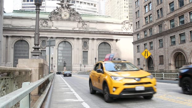 New York City, United States - 4 Sept 2023: Grand Central Terminal railway station building, 42 street. Manhattan Midtown. Yellow taxi cab, car transport on bridge, USA. American urban road traffic.
