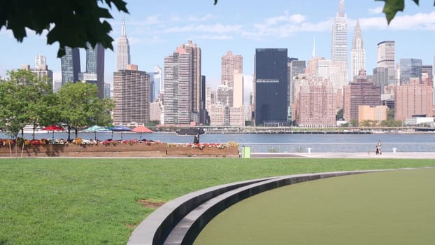 New York City, United States - 30 Aug 2023: Waterfront skyline, Manhattan Midtown buildings, riverfront skyscrapers, East river water. Waterside cityscape view from Hunters Point, Long Island, Queens.