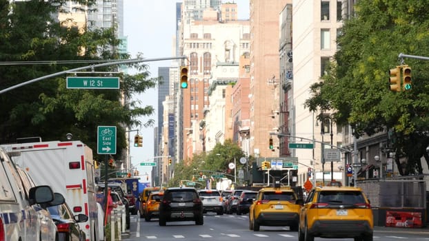 New York City, United States - 10 Sept 2023: Manhattan Greenwich Village street, Sixth 6 Americas avenue crossroad. Urban road car traffic in USA. People, zebra, yellow taxi cab. Red brick buildings.