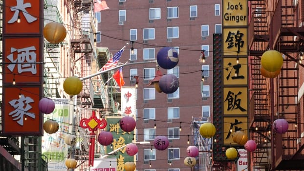 New York City, United States - 14 Sept 2023: Manhattan Chinatown Pell street. Chinese culture, ethnic district architecture, USA. Red brick buildings, paper lanterns and hieroglyph signs. Little China