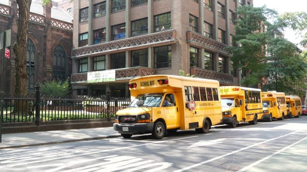 New York City, United States - 8 Sept 2023: Row of yellow school bus truck, Manhattan street road. USA children education and transportation. American shuttle near Presbyterian Church, Fifth 5 avenue.