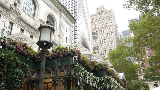 New York City, United States - 13 Sept 2023: Manhattan Midtown Bryant Park with Public library, 42 street and 5th Fifth 5 avenue. USA landmark. Summer cafe greenery, garden flowers bloom and building.