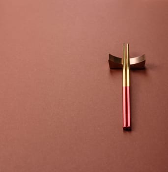 Chopsticks for sushi or other Japanese or Chinese food on a brownstone table. Asian chopsticks