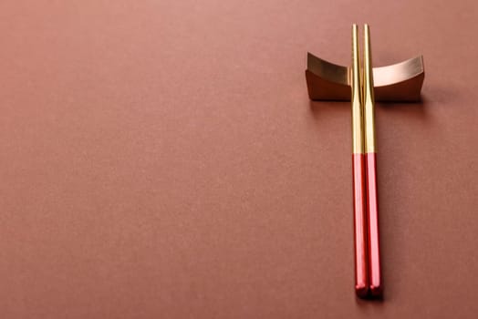 Chopsticks for sushi or other Japanese or Chinese food on a brownstone table. Asian chopsticks