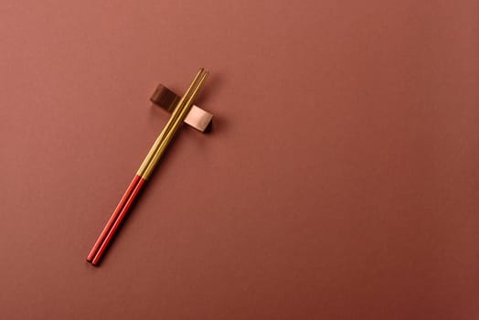 Chopsticks for sushi or other Japanese or Chinese food on a brownstone table. Asian chopsticks