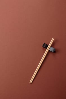 Chopsticks for sushi or other Japanese or Chinese food on a brownstone table. Asian chopsticks