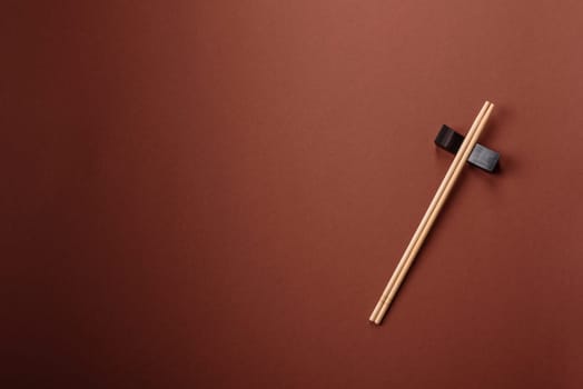 Chopsticks for sushi or other Japanese or Chinese food on a brownstone table. Asian chopsticks