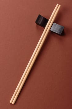 Chopsticks for sushi or other Japanese or Chinese food on a brownstone table. Asian chopsticks