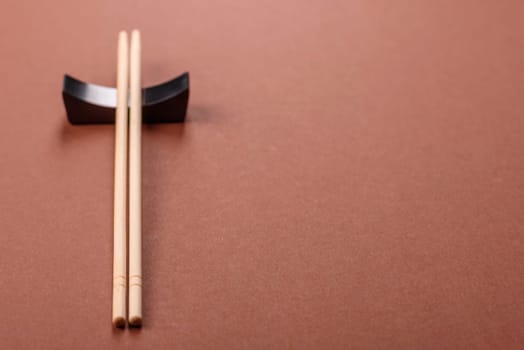 Chopsticks for sushi or other Japanese or Chinese food on a brownstone table. Asian chopsticks
