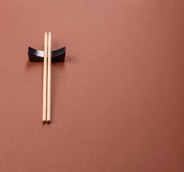 Chopsticks for sushi or other Japanese or Chinese food on a brownstone table. Asian chopsticks