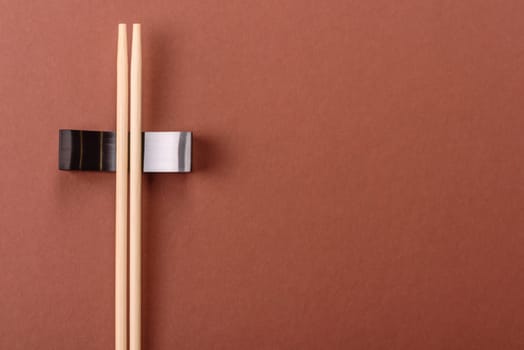 Chopsticks for sushi or other Japanese or Chinese food on a brownstone table. Asian chopsticks