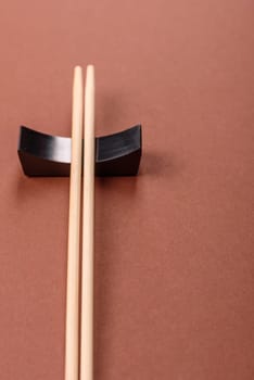 Chopsticks for sushi or other Japanese or Chinese food on a brownstone table. Asian chopsticks