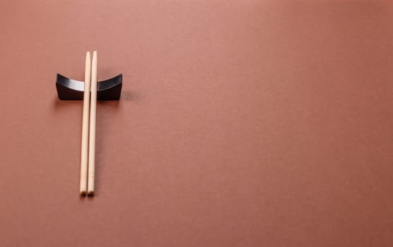 Chopsticks for sushi or other Japanese or Chinese food on a brownstone table. Asian chopsticks