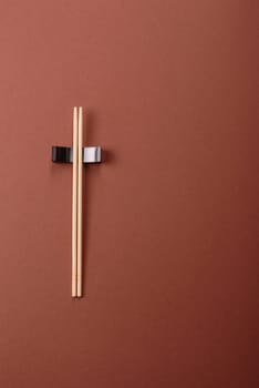 Chopsticks for sushi or other Japanese or Chinese food on a brownstone table. Asian chopsticks