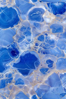 A stunning blue marble background featuring silver veins and intricate cracks, creating a luxurious and artistic design. Ideal for modern and sophisticated projects.