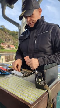 October 17 2024 Hrensko Czech Republic Europe - Ticket collector ferry men people tickets tourism transport shotlisttravel outdoor travel editorial summer day park ship. High quality photo