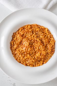 Tomato risotto plated simply with vibrant warmth