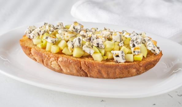Golden toast hugs melted blue cheese, sweet apples, and warm honey drizzle