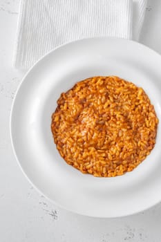 Tomato risotto plated simply with vibrant warmth