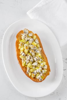Golden toast hugs melted blue cheese, sweet apples, and warm honey drizzle