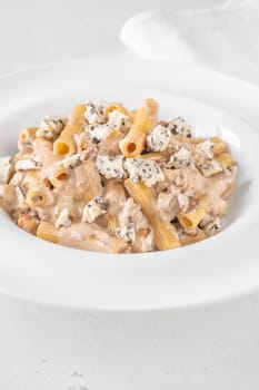 Soft penne coated in rich walnut sauce with crumbled sharp blue cheese