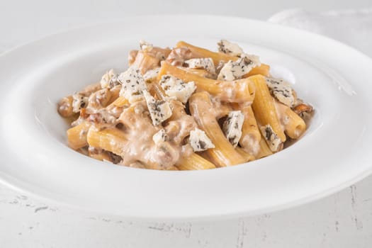 Soft penne coated in rich walnut sauce with crumbled sharp blue cheese