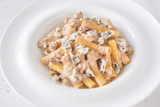 Soft penne coated in rich walnut sauce with crumbled sharp blue cheese