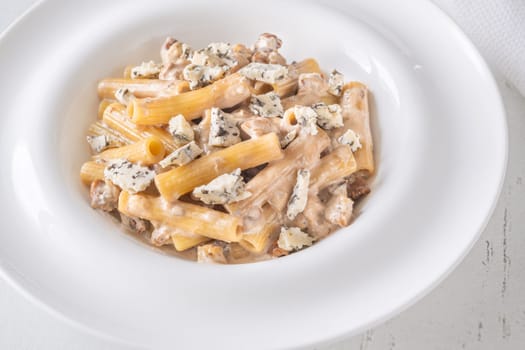 Soft penne coated in rich walnut sauce with crumbled sharp blue cheese