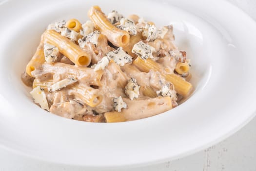 Soft penne coated in rich walnut sauce with crumbled sharp blue cheese