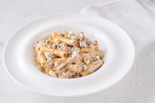 Soft penne coated in rich walnut sauce with crumbled sharp blue cheese