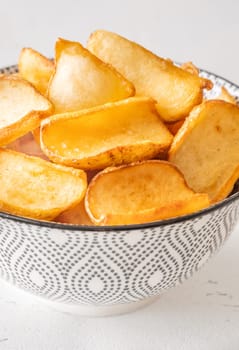 Crispy fried dippers rest warmly in bowl, perfect for salty snacking joy