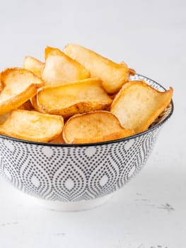 Crispy fried dippers rest warmly in bowl, perfect for salty snacking joy